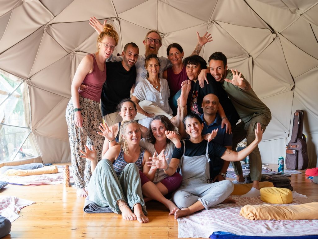 Group photo after a Thai Yoga Massage practitioner training with everyone doing a funny gesture
