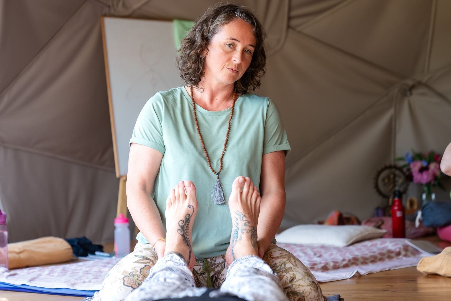 Katrin holding student's heels and observing the rest of the body