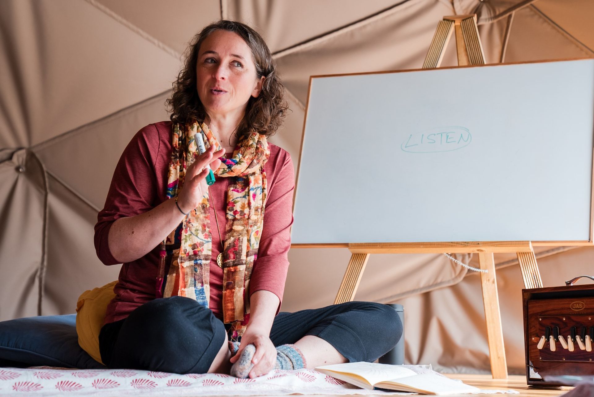Katrin sitting next to a whiteboard talking about listening